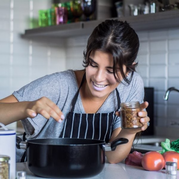 A cheerful mom cooking.