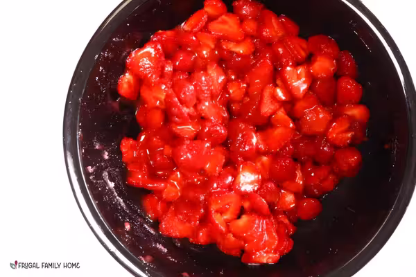 Sliced strawberries with sugar stirred in.
