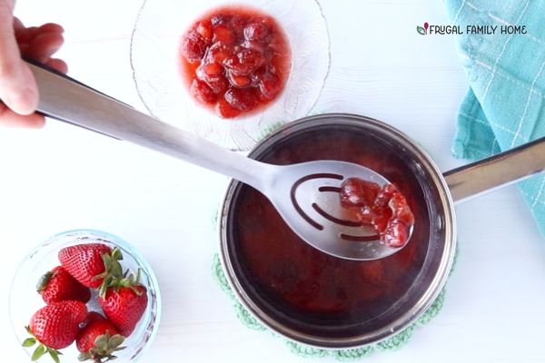 Straining the strawberries for simple syrup