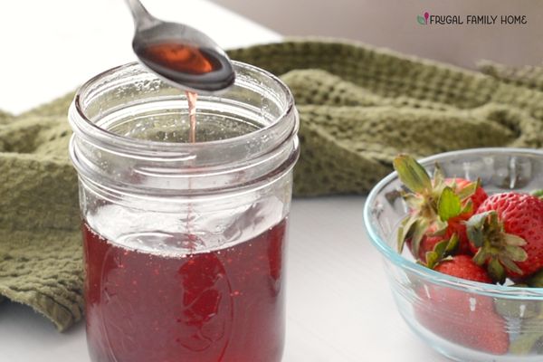The strawberry simple syrup in a jar ready to use.