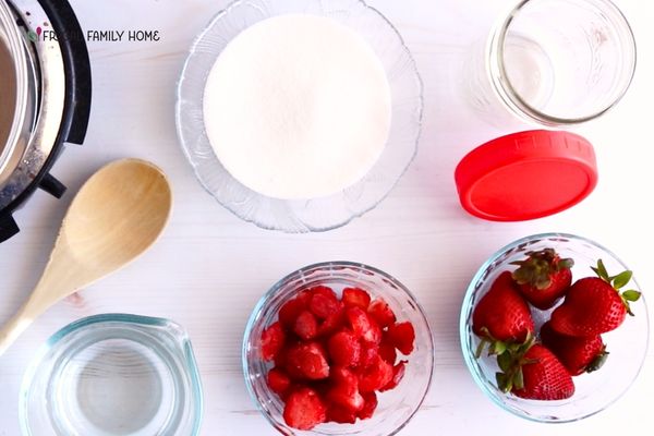 The ingredients needed to make homemade strawberry simple syrup from fresh berries.