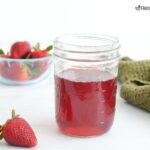 Homemade strawberry simple syrup recipe in a jar.
