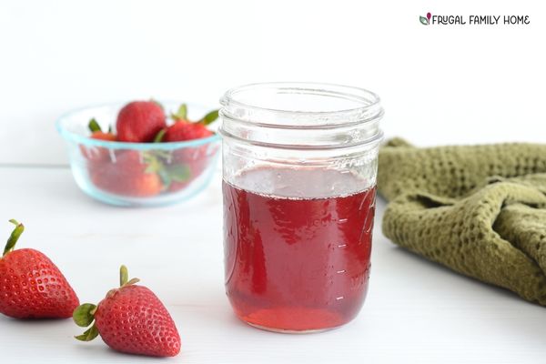 Homemade strawberry simple syrup recipe in a jar.